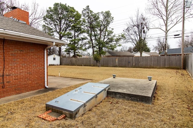 view of storm shelter featuring a lawn