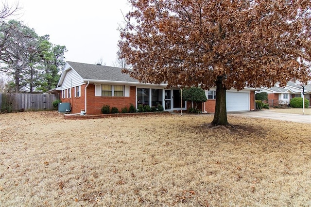 view of front of house with a garage and central AC