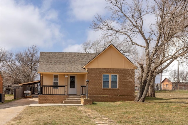 view of front of home with a carport, central AC unit, covered porch, and a front lawn