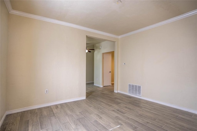 unfurnished room featuring crown molding and light hardwood / wood-style flooring