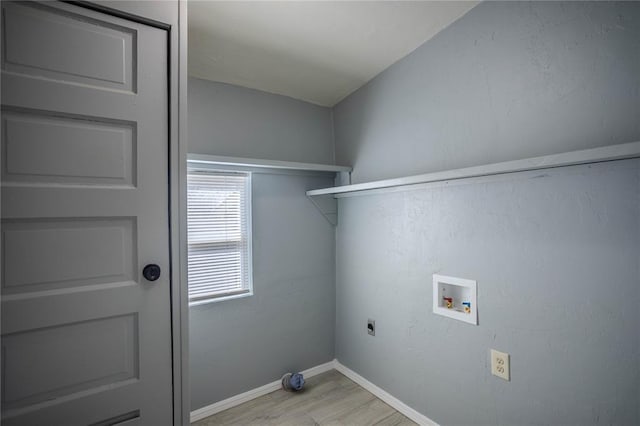 laundry area with hookup for an electric dryer, washer hookup, and light wood-type flooring