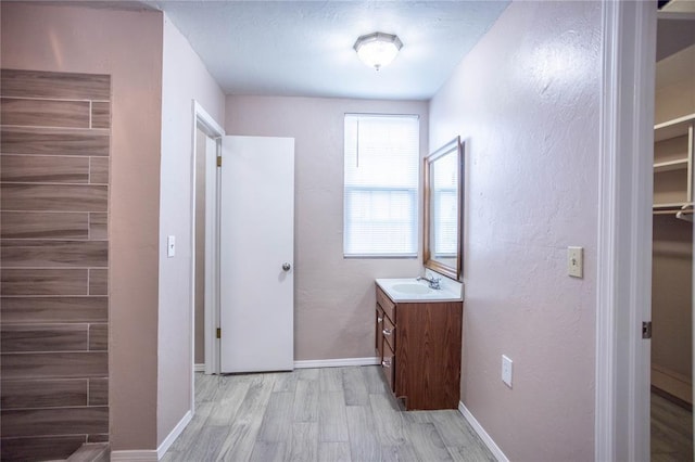 hallway featuring sink and light wood-type flooring