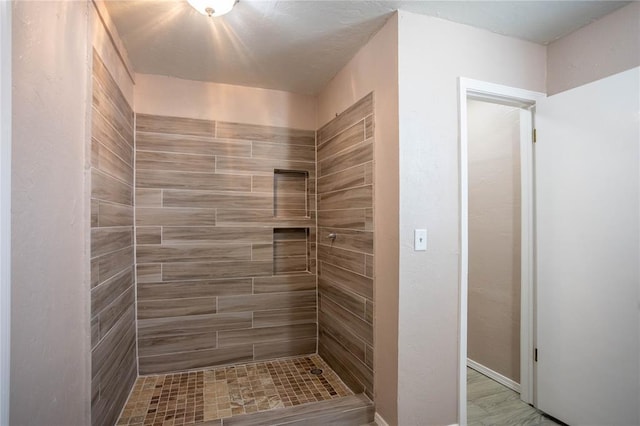 bathroom with tiled shower