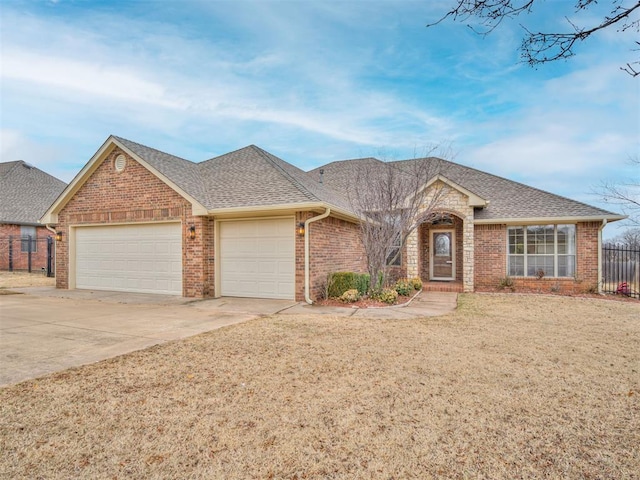 ranch-style home with a garage and a front yard