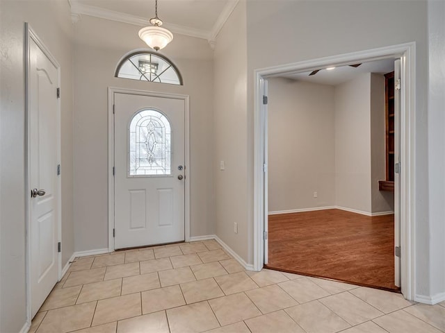 tiled foyer with ornamental molding