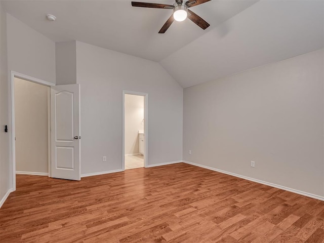 unfurnished bedroom with vaulted ceiling, ceiling fan, ensuite bathroom, and light hardwood / wood-style floors