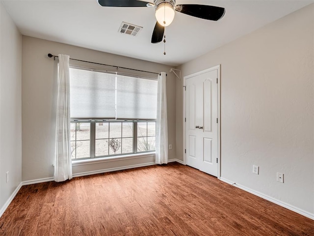 unfurnished room featuring wood-type flooring and ceiling fan