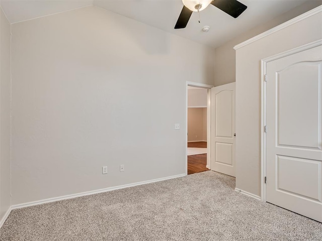 unfurnished bedroom with ceiling fan, lofted ceiling, and carpet floors