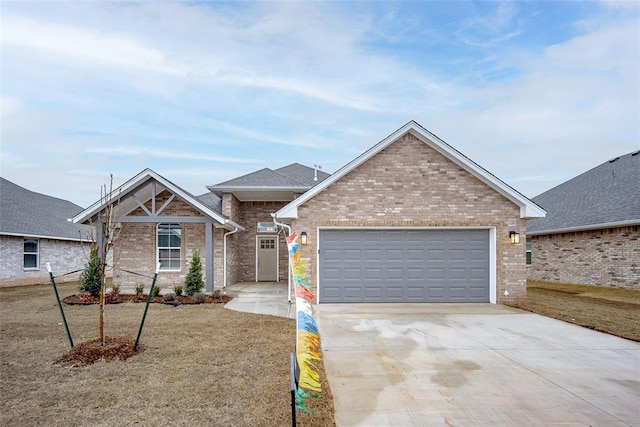 view of front of house featuring a garage and a front lawn