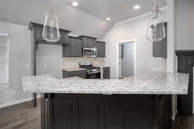 kitchen featuring gray cabinets, lofted ceiling, backsplash, stainless steel appliances, and dark wood-type flooring