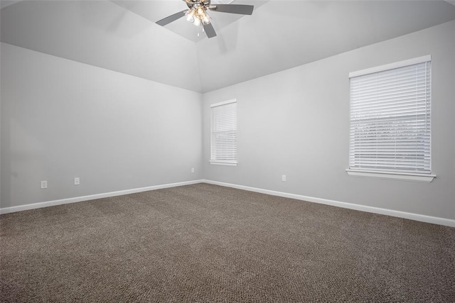 spare room with vaulted ceiling, ceiling fan, and carpet flooring