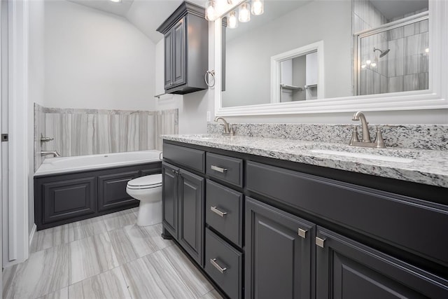 bathroom with vanity, lofted ceiling, and toilet