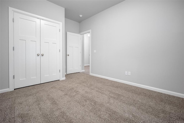 unfurnished bedroom with a closet and carpet