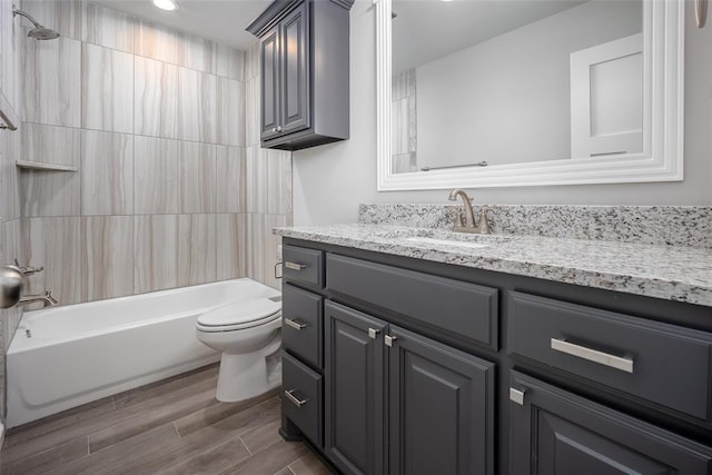 full bathroom with vanity, wood-type flooring, bathing tub / shower combination, and toilet