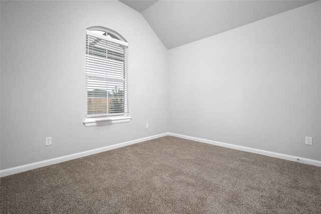 empty room with lofted ceiling and carpet