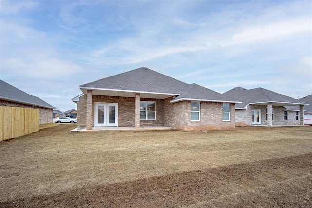 back of property featuring a yard and a patio area