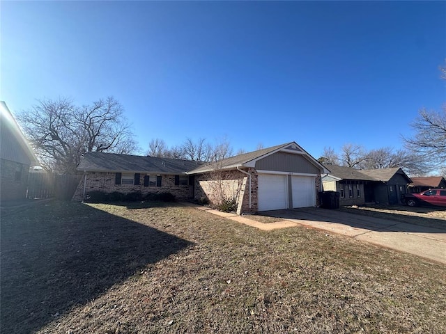 ranch-style home with a garage and a front lawn