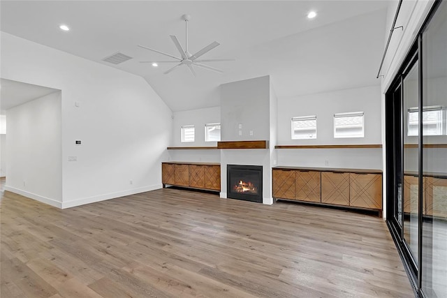 interior space featuring ceiling fan, lofted ceiling, and light hardwood / wood-style floors