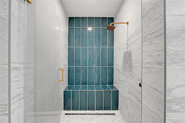 bathroom featuring a shower with door