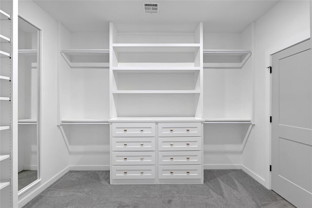 walk in closet featuring dark colored carpet