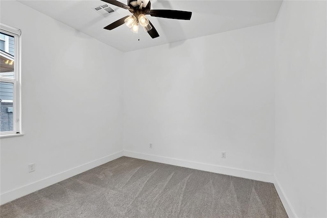 carpeted empty room with ceiling fan and plenty of natural light