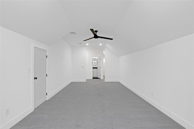 additional living space featuring vaulted ceiling, ceiling fan, and light colored carpet