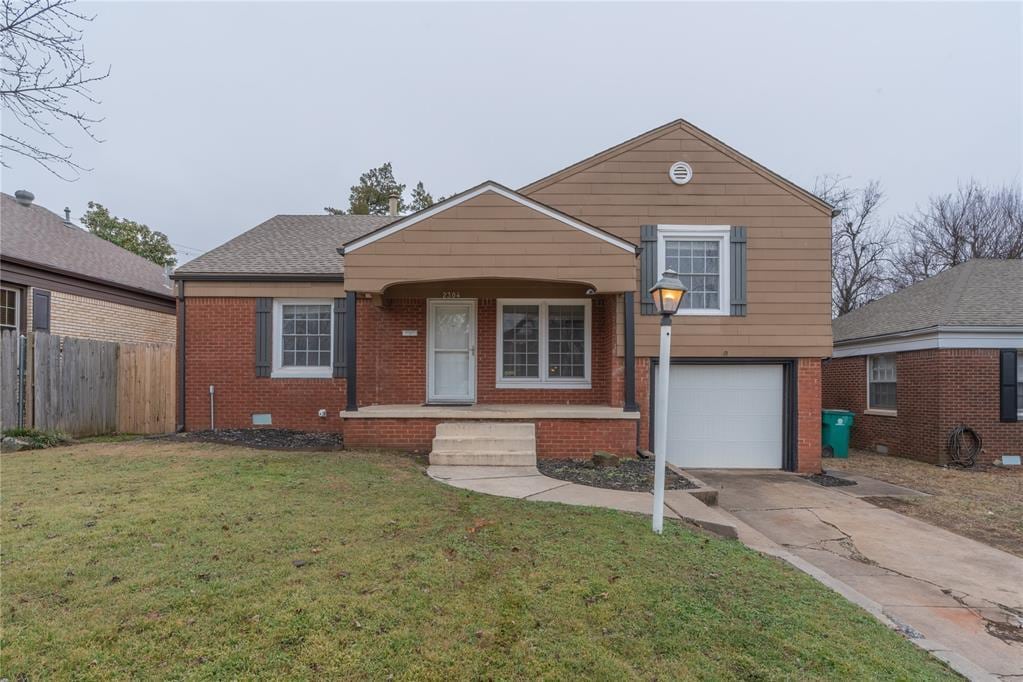 view of front of property with a garage and a front yard