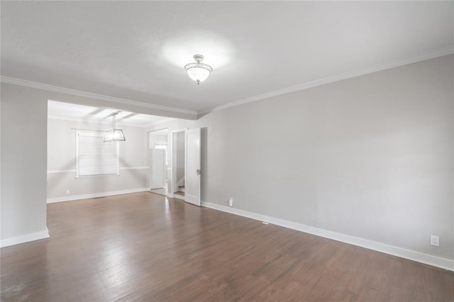 empty room with crown molding and dark hardwood / wood-style floors