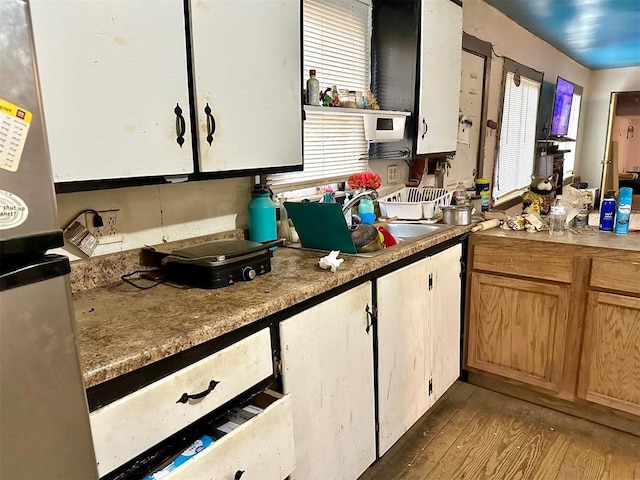 kitchen with hardwood / wood-style flooring and sink