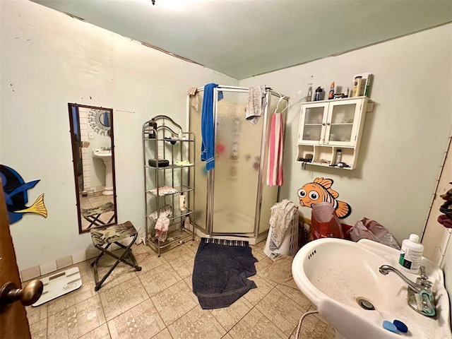 bathroom featuring walk in shower and sink