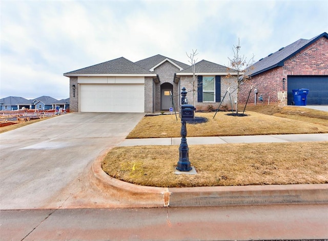 ranch-style home with a garage and a front lawn