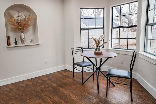 dining space with dark hardwood / wood-style floors