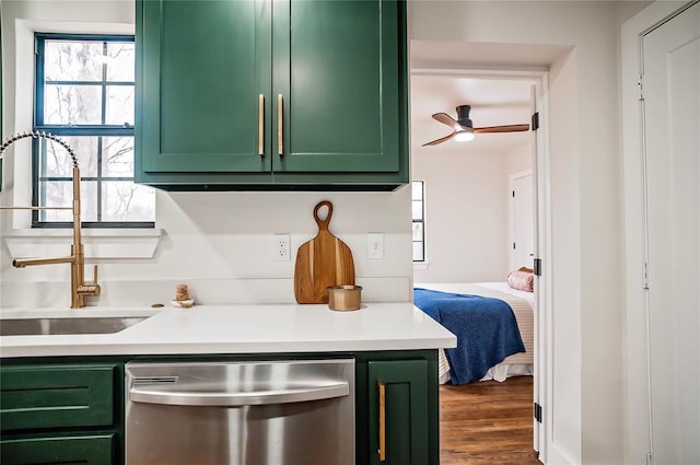 kitchen with dishwasher, sink, dark hardwood / wood-style flooring, green cabinets, and ceiling fan