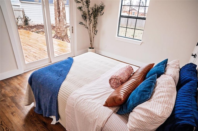 bedroom featuring hardwood / wood-style floors and access to outside