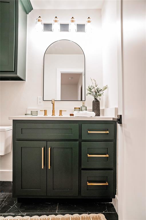 bathroom featuring vanity and toilet