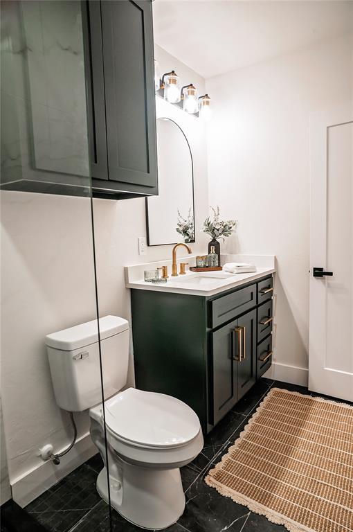 bathroom featuring vanity and toilet