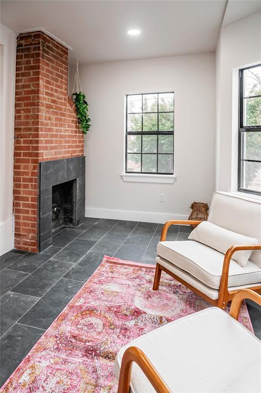 living room featuring a brick fireplace