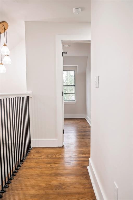 corridor with hardwood / wood-style flooring