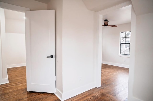 corridor with hardwood / wood-style flooring