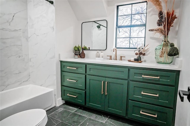 full bathroom featuring vanity, tiled shower / bath, and toilet