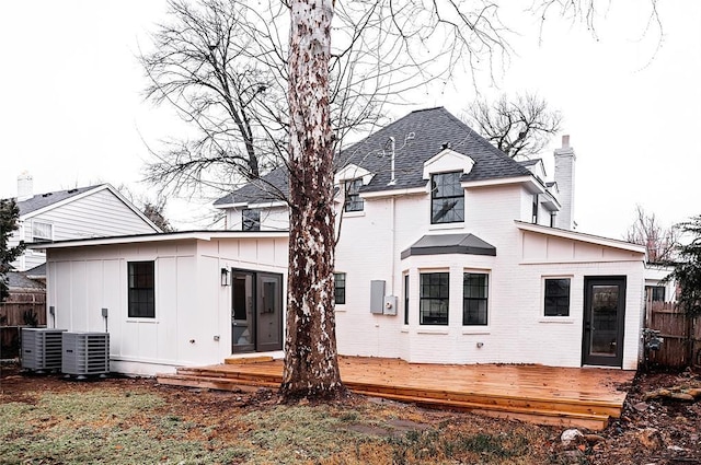 back of house featuring a wooden deck and central AC unit