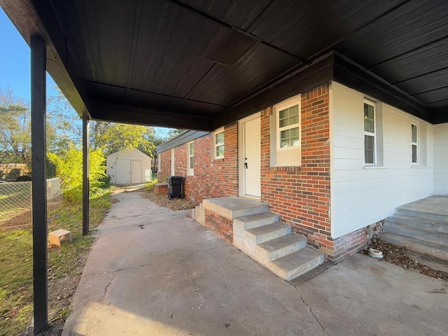 exterior space with a storage unit and a patio