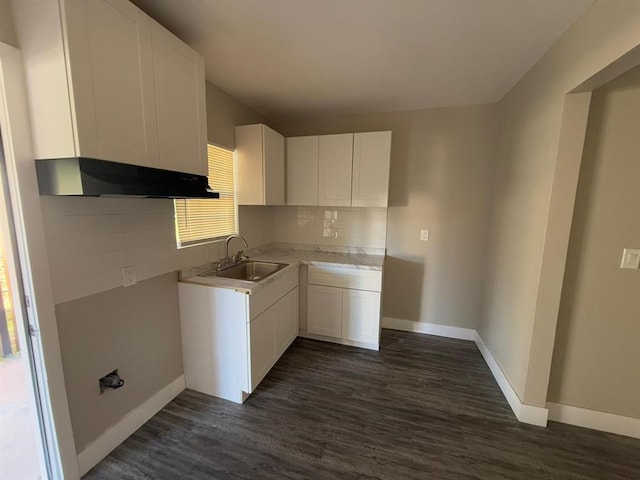 kitchen with sink, decorative backsplash, dark hardwood / wood-style floors, and white cabinets