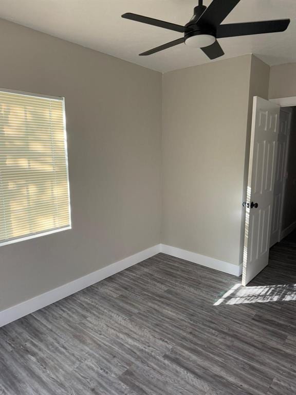 unfurnished room featuring ceiling fan and dark hardwood / wood-style flooring