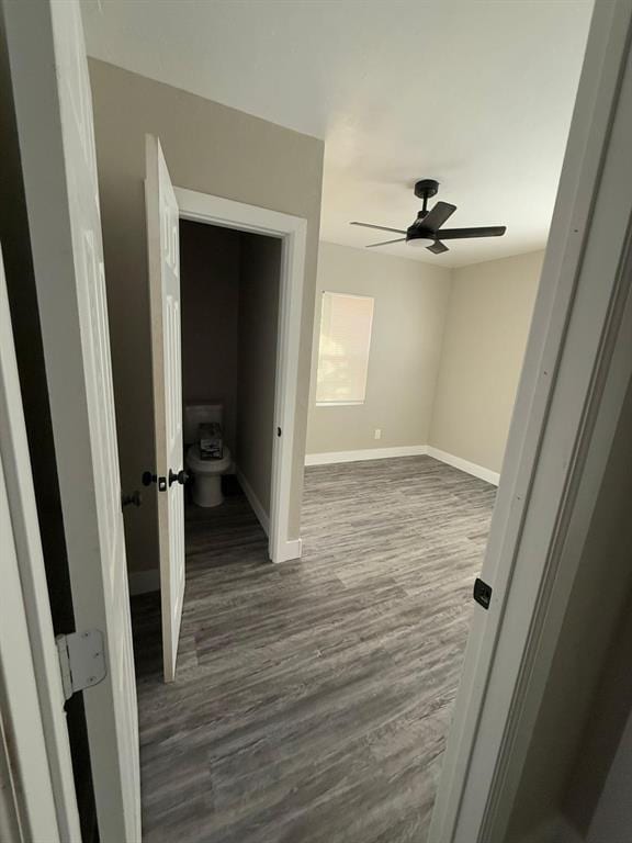 hallway with dark hardwood / wood-style flooring