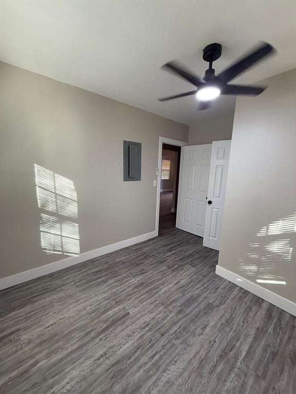 spare room featuring ceiling fan, dark hardwood / wood-style floors, and electric panel