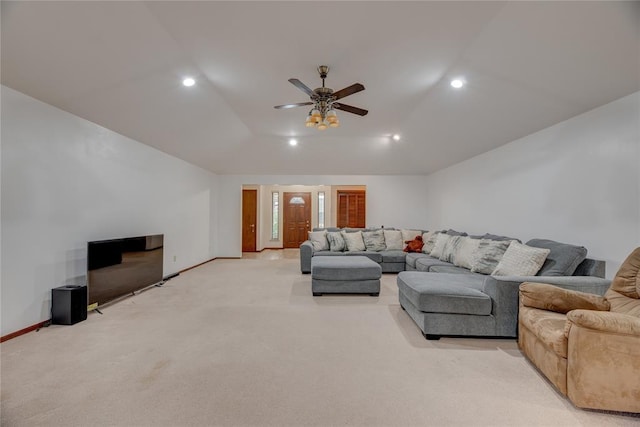 living room featuring vaulted ceiling, light carpet, and ceiling fan