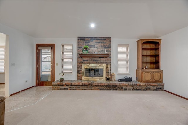 unfurnished living room with a fireplace, vaulted ceiling, and light carpet