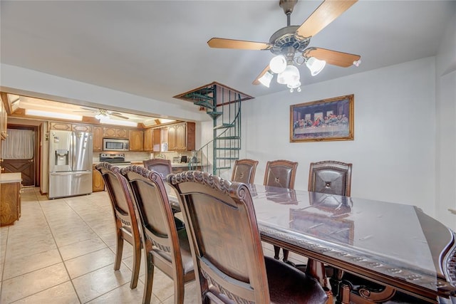 tiled dining room featuring ceiling fan