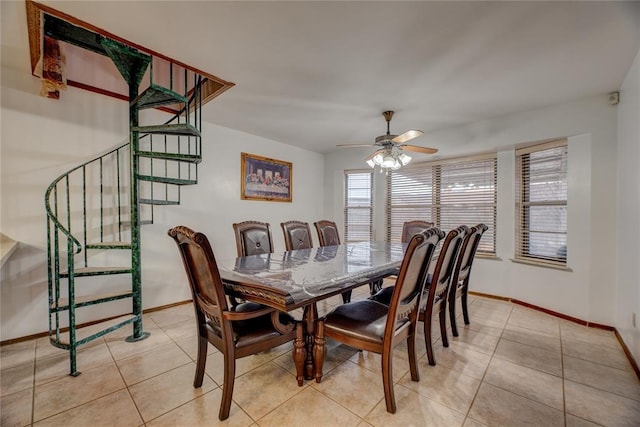 tiled dining space featuring ceiling fan